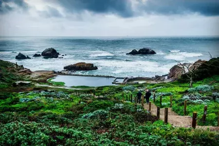 Hikers explore San Francisco's Sutro Baths near the Pacific Ocean