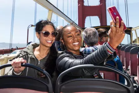 Friends taking selfies on the Golden Gate Bridge