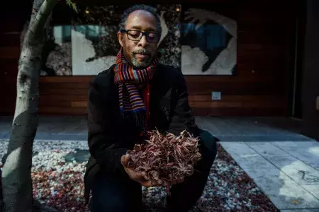 Ron Moultrie Saunders holding leaves.