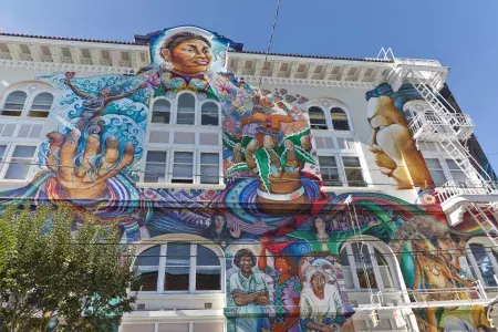 Ein farbenfrohes, großformatiges Wandgemälde bedeckt die Seite des Women's Building im Mission District von San Francisco.