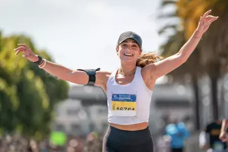 A woman finishes running the San Francisco Marathon