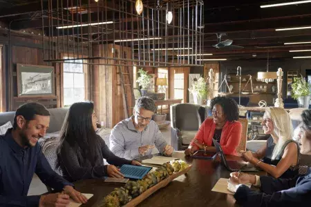 A group collaborates at a meeting in Monterey.