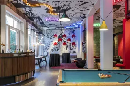 Image of interior of Hotel Zeppelin, pool table and neon lights in view.