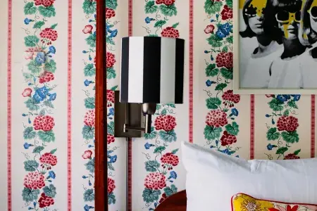 Room at White Swan Inn, floral wall paper with pop art painting over bed. 