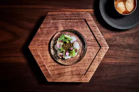Dish served on hexagonal wooden dish at Aphotic