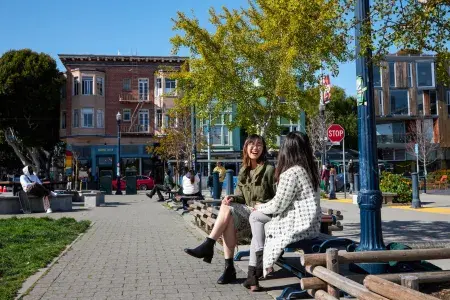 Women sit outside at Patricia's Green in San Francisco's Hayes Valley.