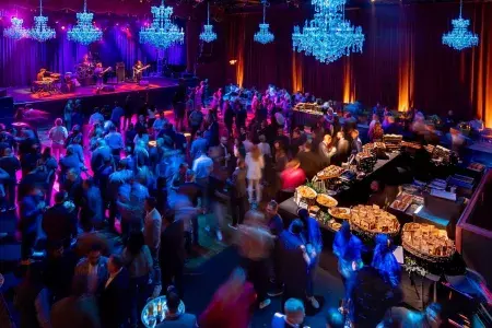 Image of a crowded Live nation event with catering and a live performance