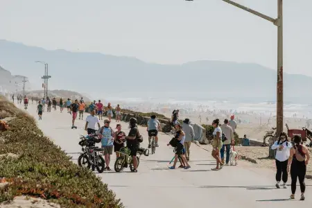 Visitors explore Sunset Dunes on a bright, sunny day.