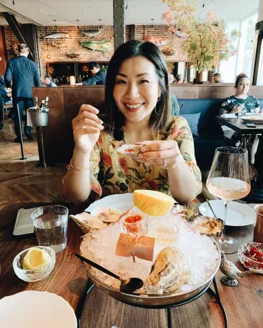 A woman enjoys fresh seafood at San Francisco's Angler restaurant