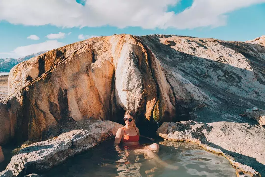 A woman relaxes in a natural hot spring beyond San Francisco.