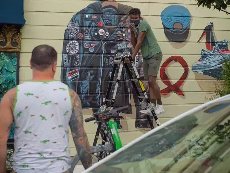 Serge Gay Jr painting his mural last year