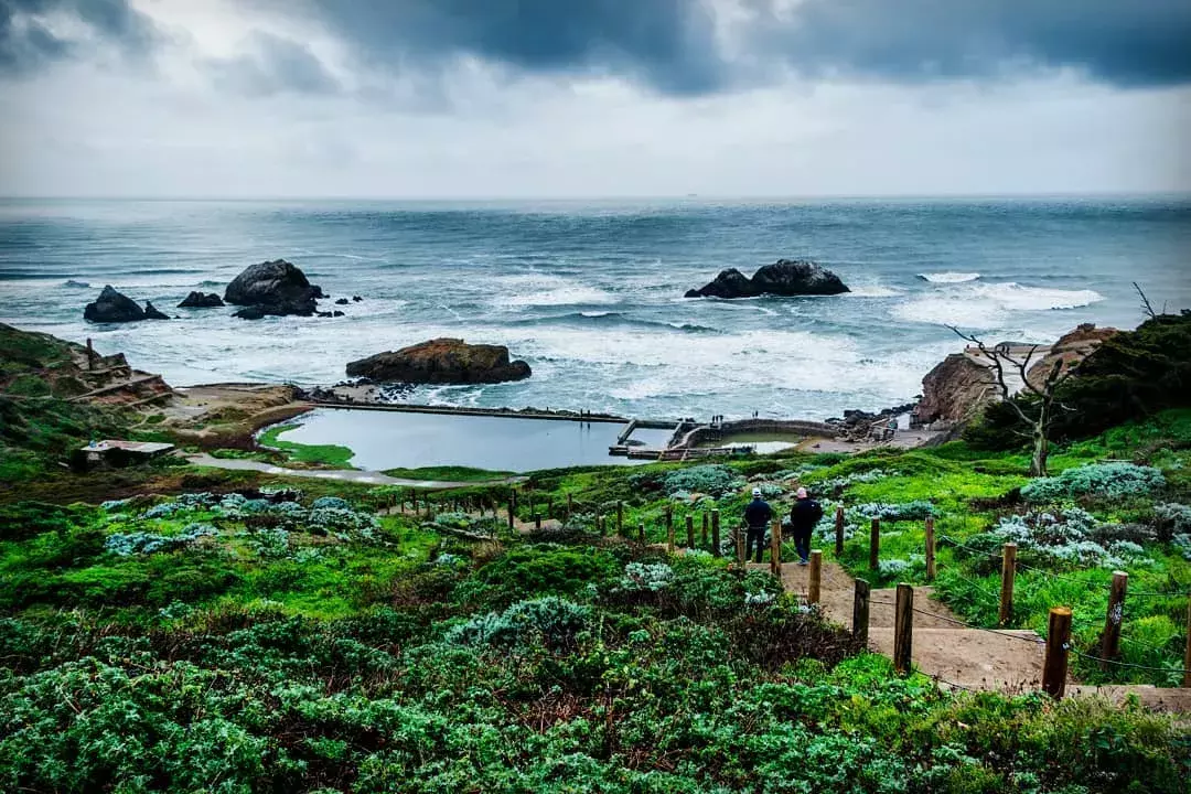 Hikers explore San Francisco's Sutro Baths near the Pacific Ocean