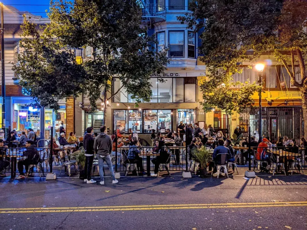 A crowd enjoys food and drink along San Francisco's Valencia Street