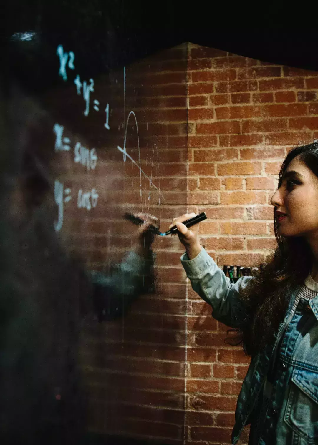 Ayman Nadeem writing on a whiteboard.