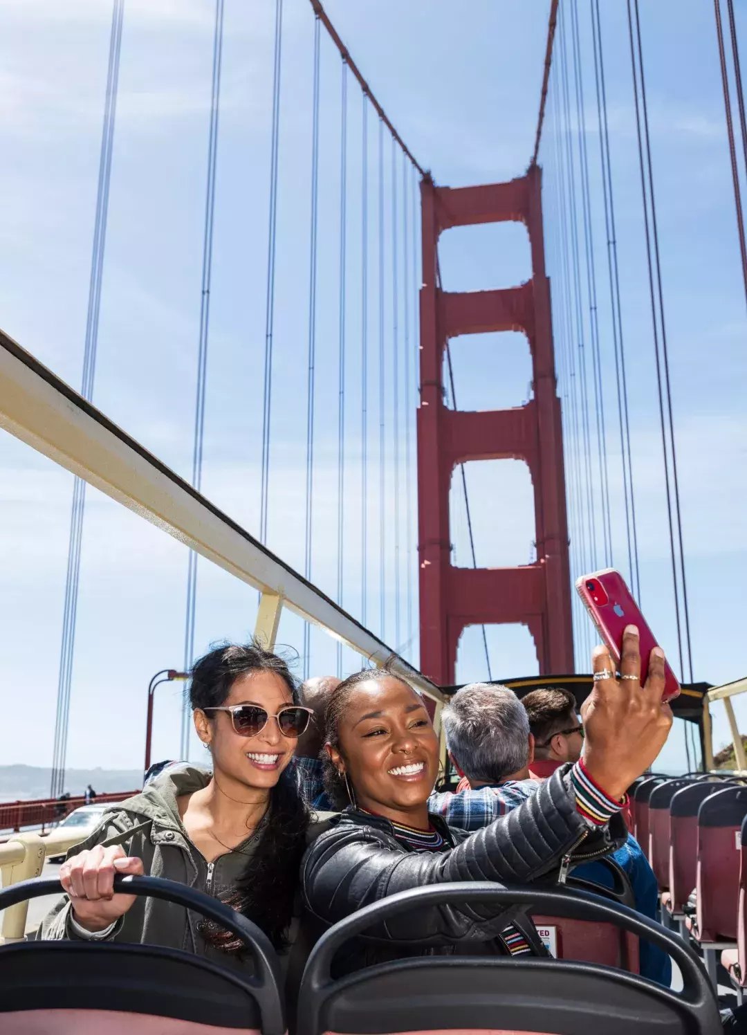 Friends taking selfies on the Golden Gate Bridge