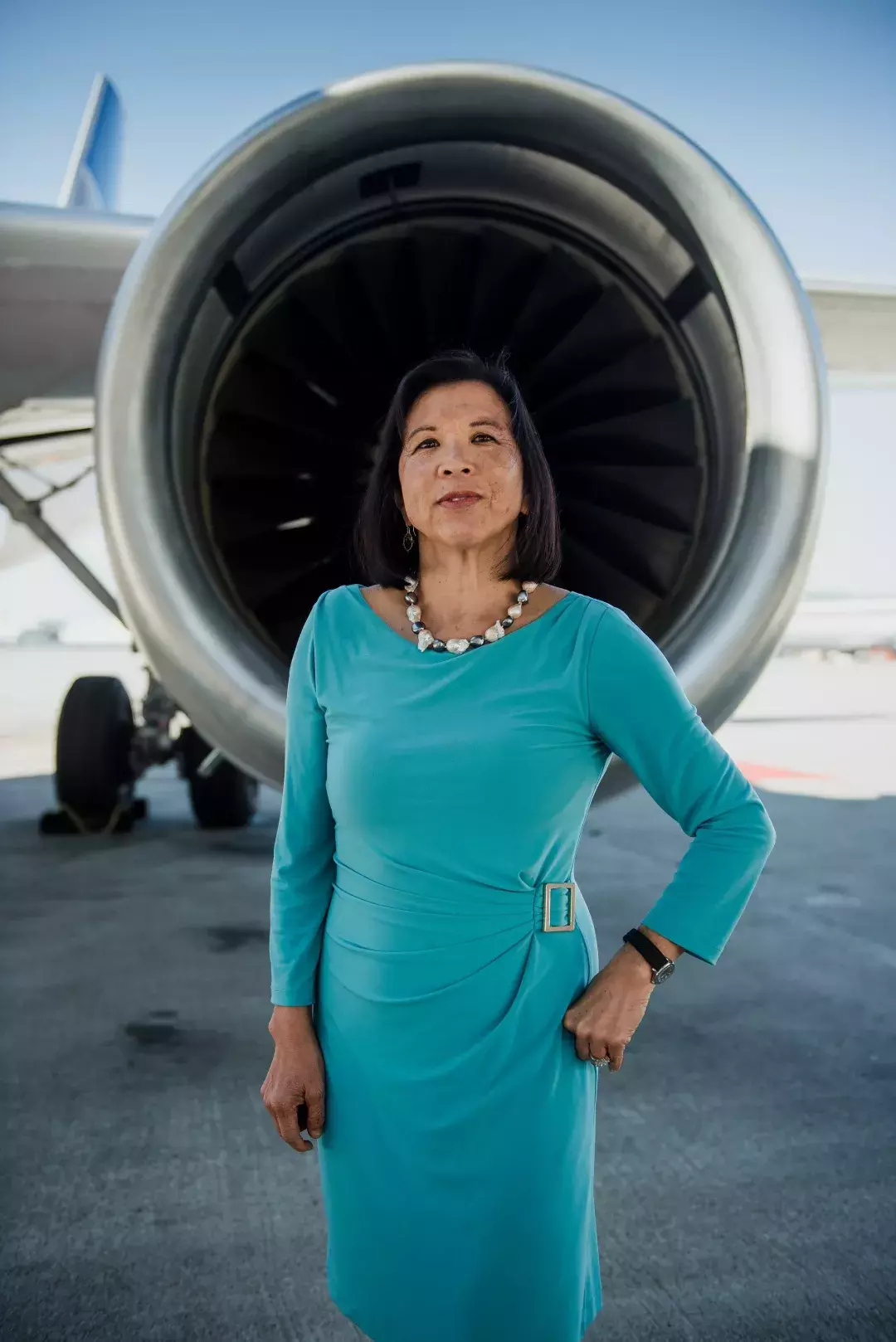 Melinda Yee Franklin standing in front of a United plane.