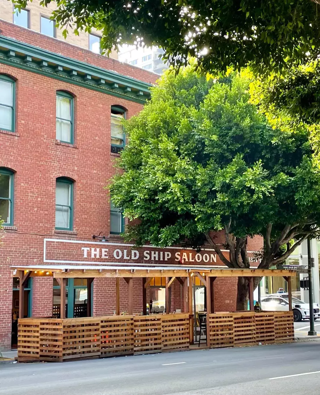 exterior of brick building with large, painted letter that read "old ship saloon"