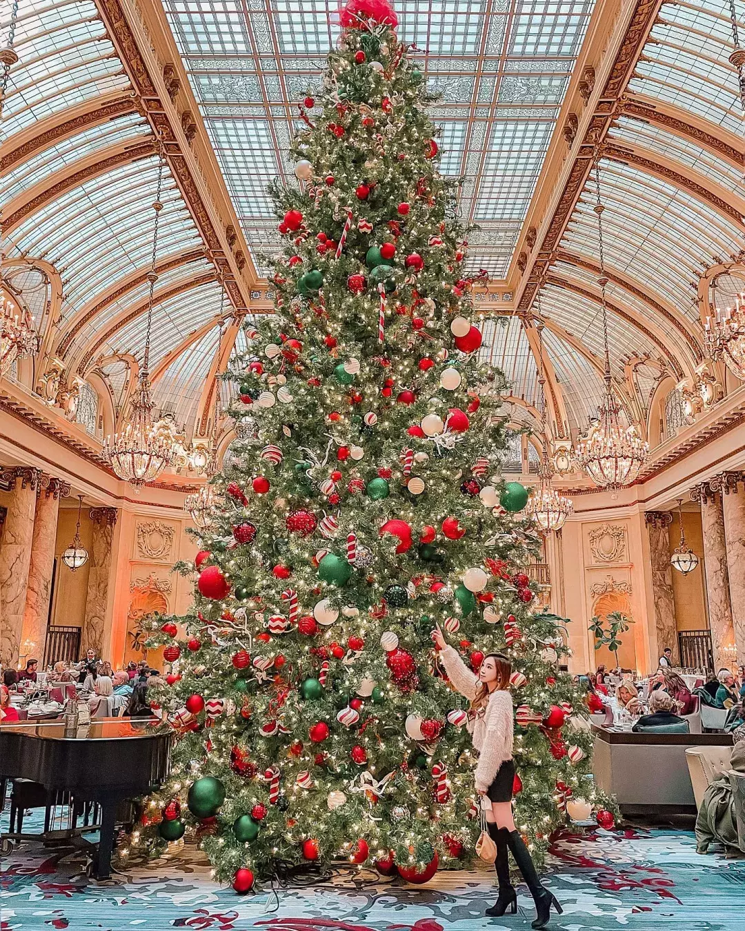 woman standing by elaborate xmas tree at Palace Hotel in San Francisco