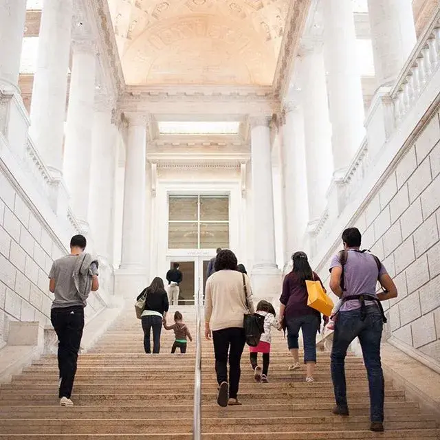 Visitors climb the main staircase of the Asian Art Museum