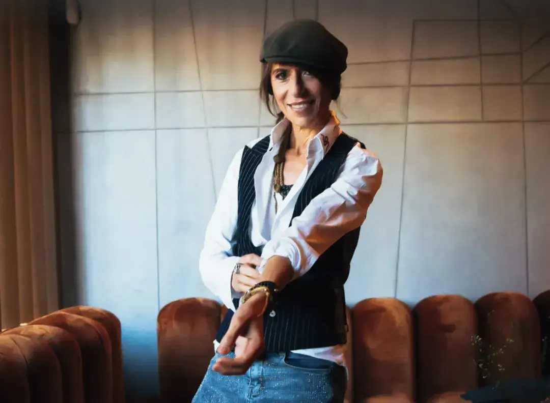 Image of Michelin Star chef, Dominique Crenn rolling up her sleeves In a headshot