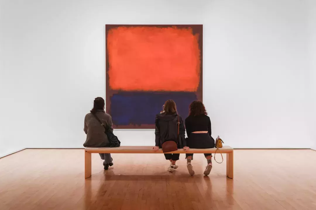 Museum patrons looking at Rothko painting on a bench