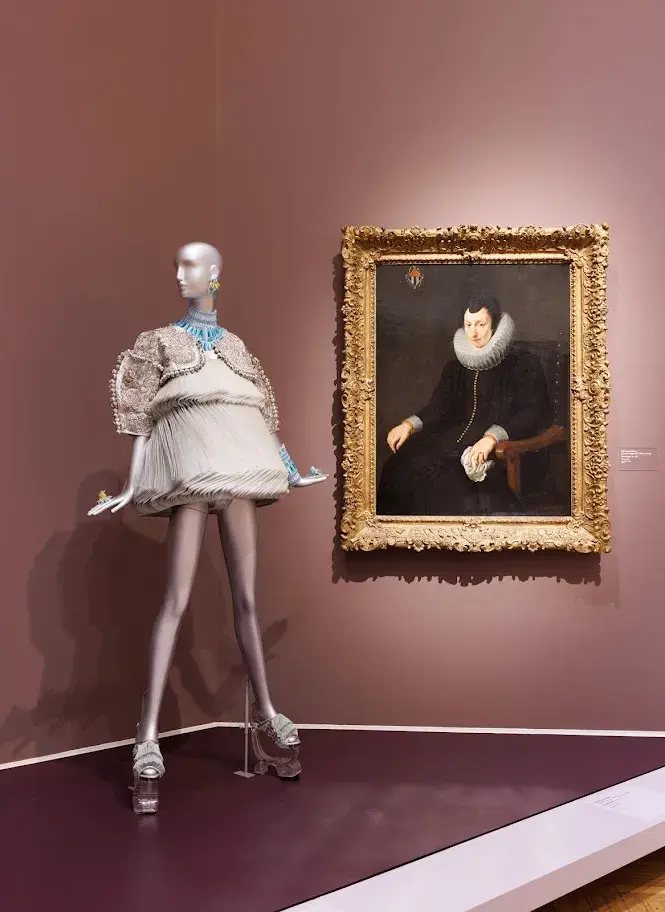 Image of mannequin next to painting