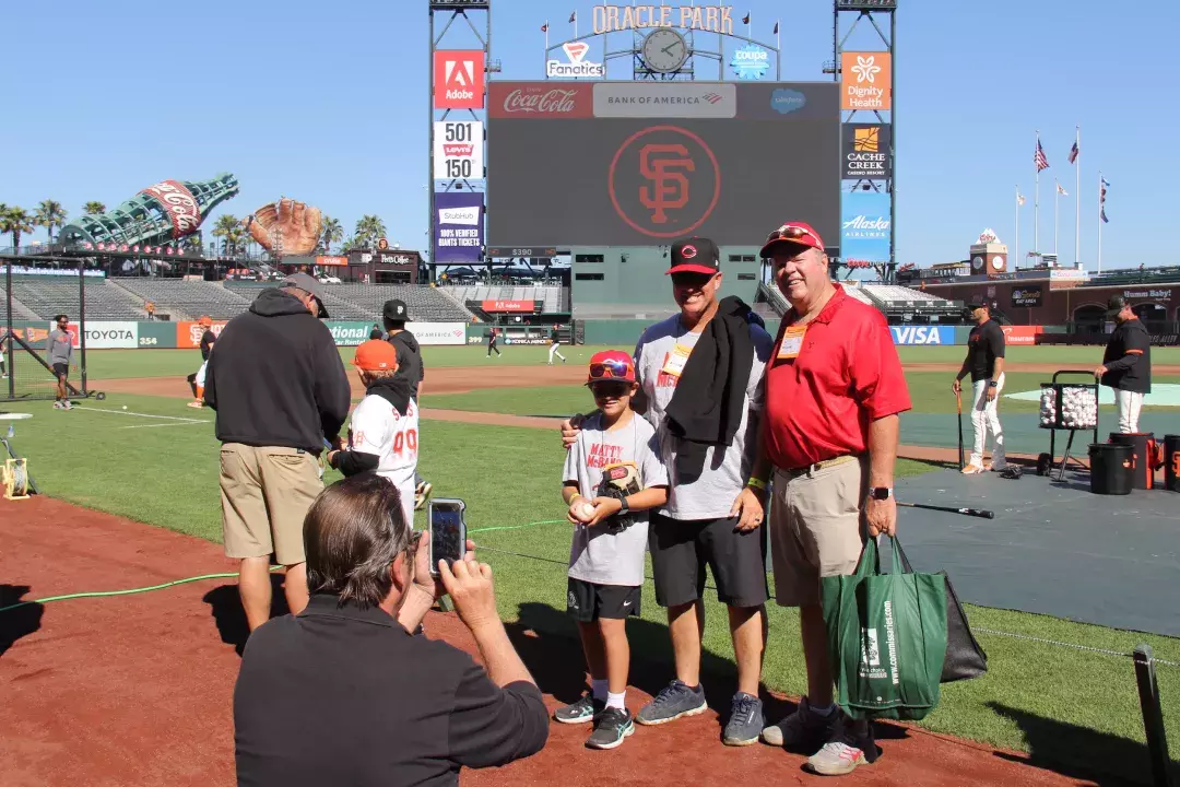 Visitors have their photo taken on the field at Oracle Park.