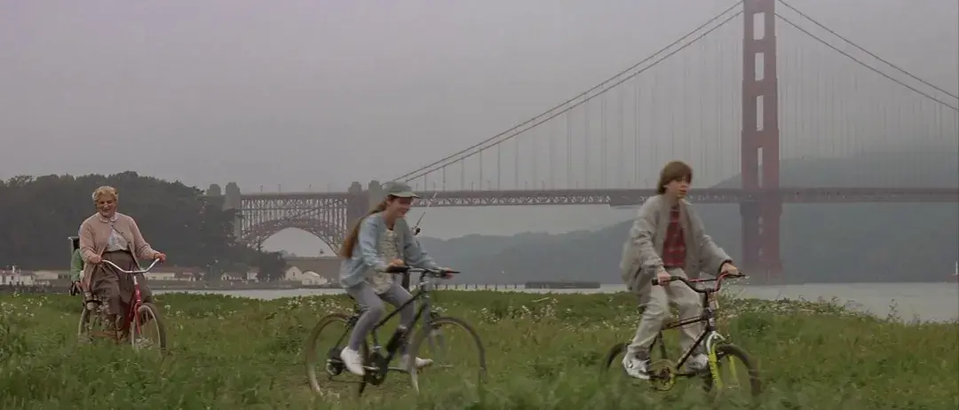 Mrs. Doubtfire and children riding bikes in Crissy Field