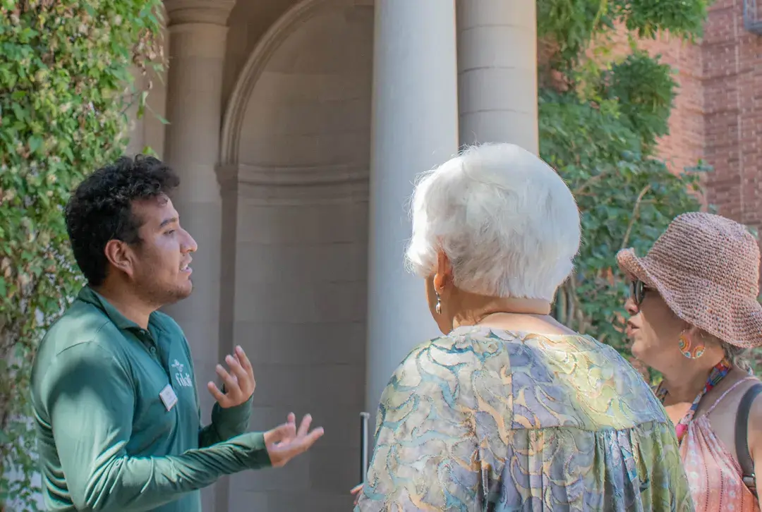 A guide discusses the history and horticulture of Filoli with guests.