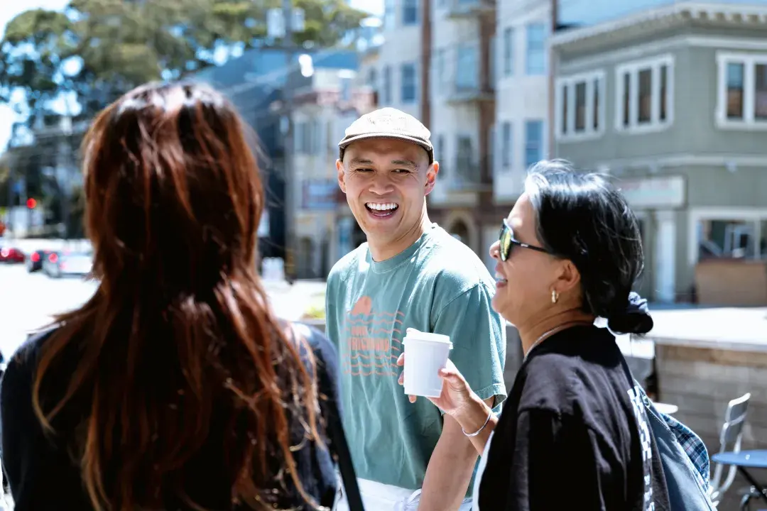Breadbelly owner Clement Hsu talks with customers outside his bakery in San Francisco's Richmond District.
