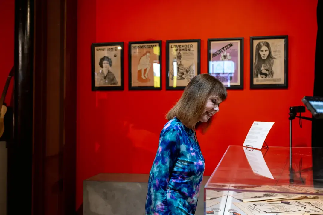 Founder Estelle Cimino examines a display at The Counterculture Museum