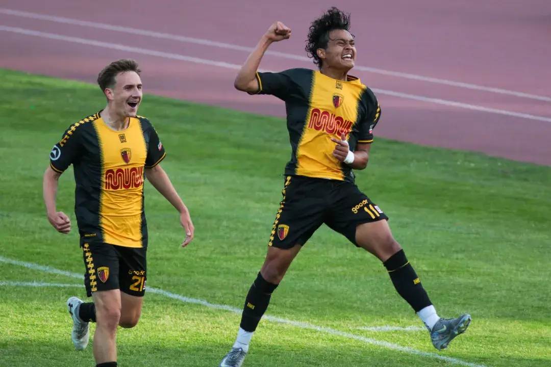 SF City FC players jumping for joy on Kezar Stadium field