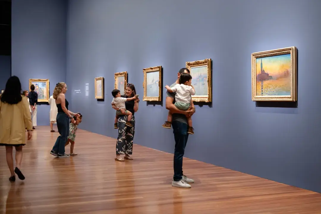 Visitors to the de Young Museum view Monet's Venetian paintings.