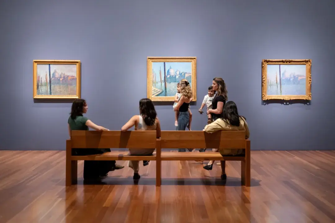 Visitors to the de Young Museum view Monet's Venetian paintings.