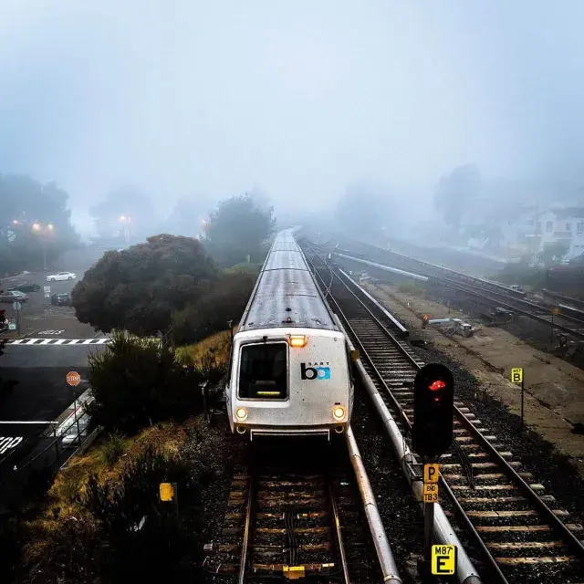 A Bay Area Rapid Transit (BART) train runs on a foggy day in San Francisco.