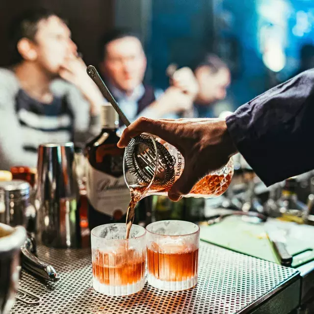 Bartender pouring cocktails