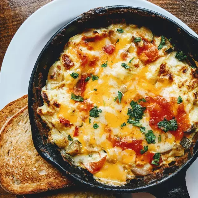 A bowl of macaroni and cheese served in a skillet.