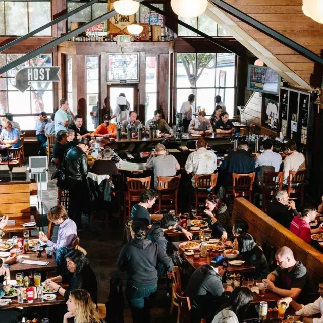 Patrons eat and drink inside the 21st Amendment Brewery in San Francisco.