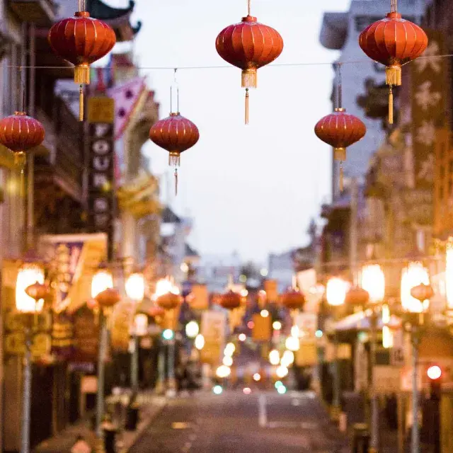 Close-up view of a string of red lanterns hanging above a street in Chinatown. San Francisco, California.