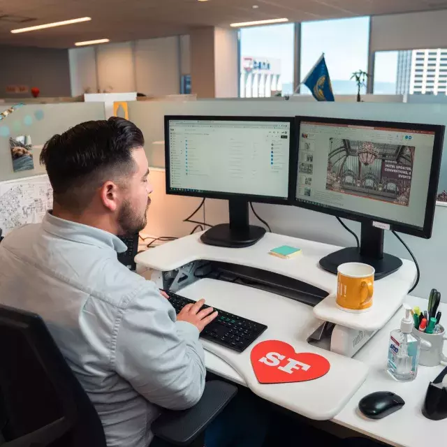 Man at the computer pretending to type, not doing any real work.