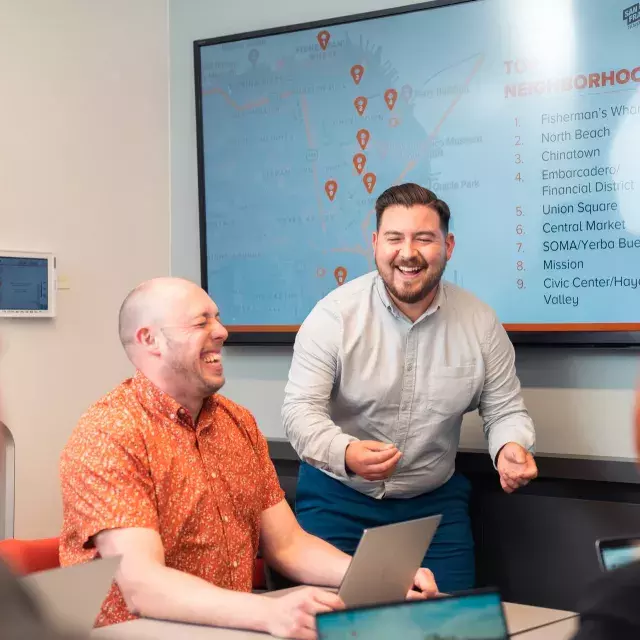 Man facilitating a meeting. He made someone laugh.