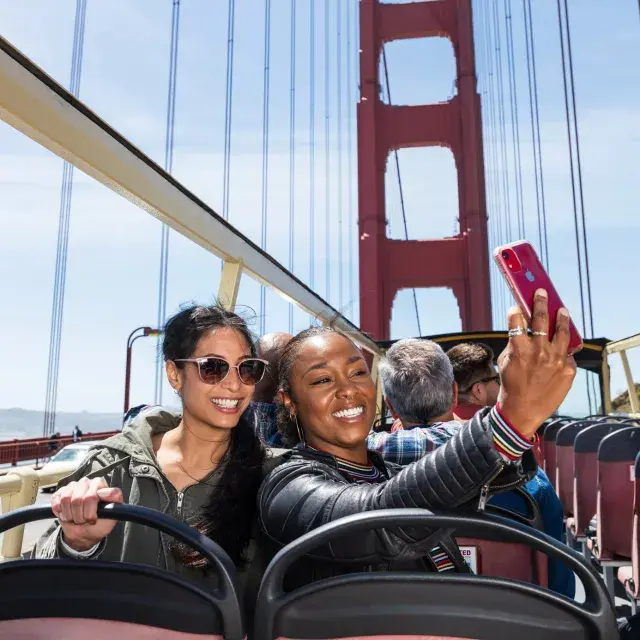 Friends taking selfies on the Golden Gate Bridge
