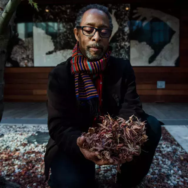 Ron Moultrie Saunders holding leaves.