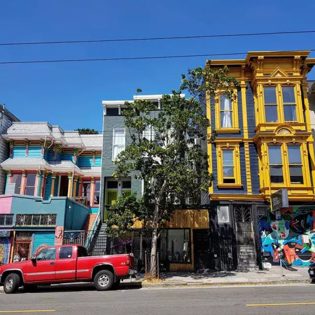 View of colorful buildings on Haight Street with cars parked along the street. San Francisco, California.