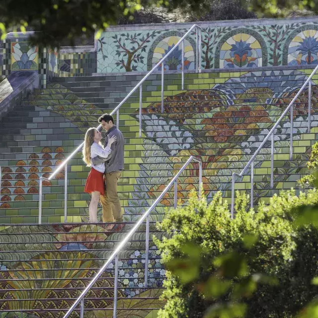 Photo taken from an angle of a couple standing on Lincoln Park's colorful tiled steps