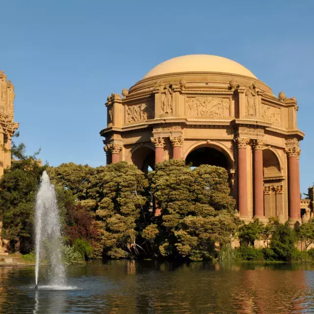 Exterior of the Palace of Fine Arts, with its lake and water fountain.