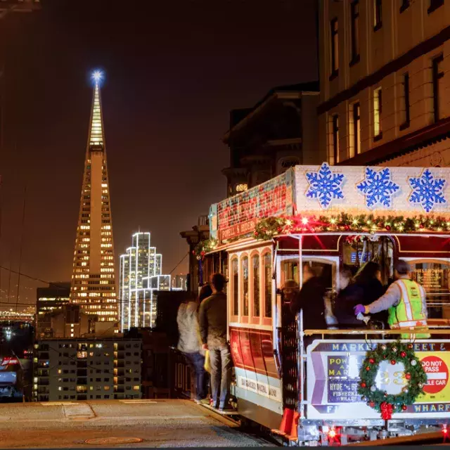 The cable cars are decorated for the holidays.