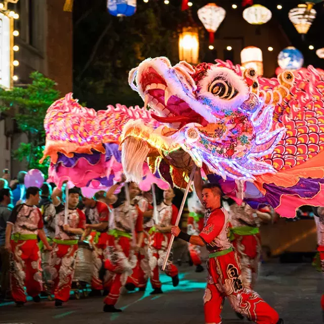 Dancers manipulate a giant, illuminated dragon during San Francisco's Lunar New Year Parade.