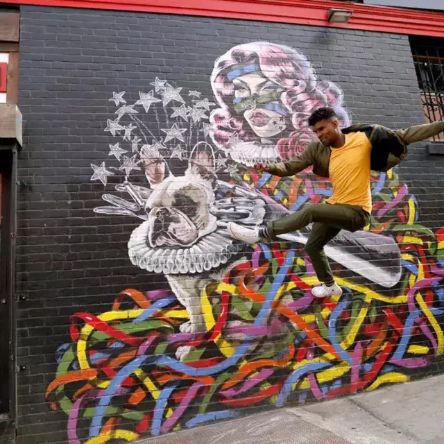 Artist Serge Gay Jr. in front of one of his many murals.