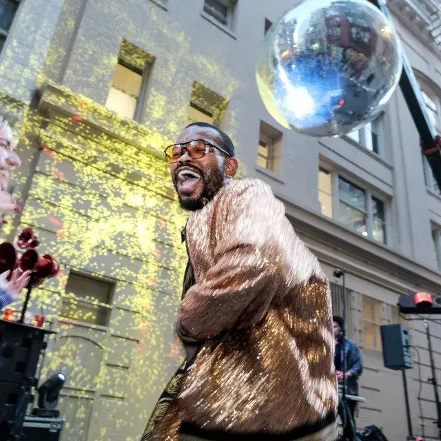 Dancer dancing under a giant disco ball in San Francisco